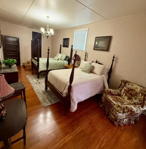 a bedroom with a bed and a chair at The Pecan House in Bainbridge