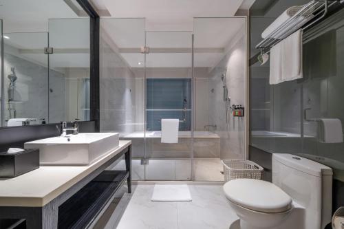 a bathroom with a sink and a toilet and a shower at Citadines South Chengdu in Chengdu