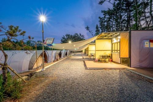 a row of tents with a street light next to it at Seocheon Ocean Place Glamping Caravan in Seocheon