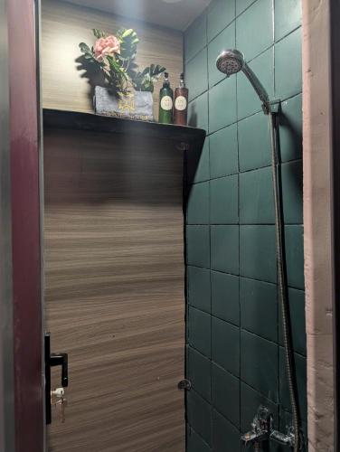 a bathroom with a shower and a wooden door at T Zone Hostel - Quiet Place, Near China Town,Ho Thi Ky Street Food,Cafe,Beer in Ho Chi Minh City