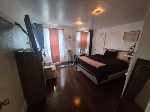 a bedroom with a bed and a television in it at Humble beginning 605 EM in Norwich