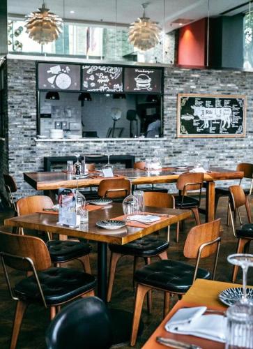 a dining room with wooden tables and chairs at Paradox Kunshan in Kunshan