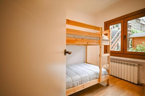 a bunk bed in a room with a window at Xalet Les Avellanes - hut 7335 in Arinsal