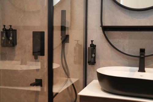 a bathroom with a sink and a shower at Sunset Premium in Keramoti