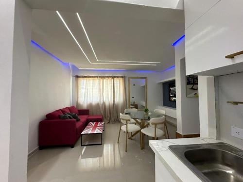 a living room with a red couch and a table at Ts02 torre B in La Romana