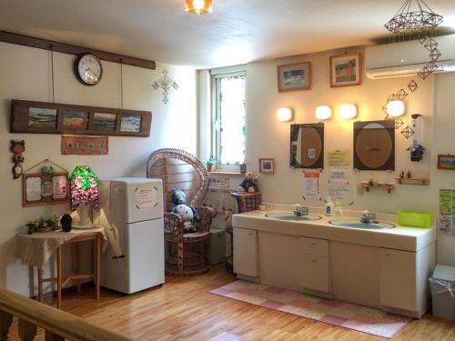 a kitchen with two sinks and a refrigerator at Natsumi no Sato in Biei