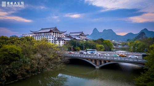 a bridge over a river with buildings and cars on it at Grand Bravo Guilin in Guilin