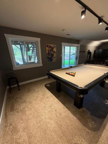 a living room with a pool table in it at Tall Trees Departure Bay Nanaimo in Nanaimo