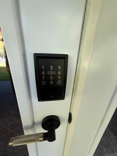 a door with a digital clock on it at Tall Trees Departure Bay Nanaimo in Nanaimo