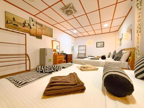 a room with two beds and towels on a bed at Seven Minutes Ella by SANS in Ella