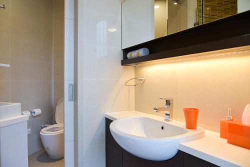a bathroom with a white sink and a toilet at Cassia Phuket, part of Banyan Group in Bang Tao Beach
