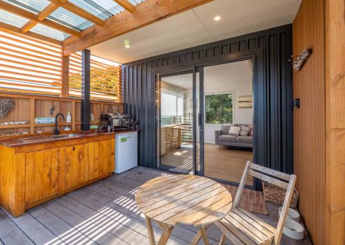 a kitchen with a table and a chair and a table at Studio at Pohara in Pohara