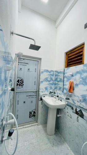a bathroom with a sink and a shower at Azura Hotel in Pottuvil