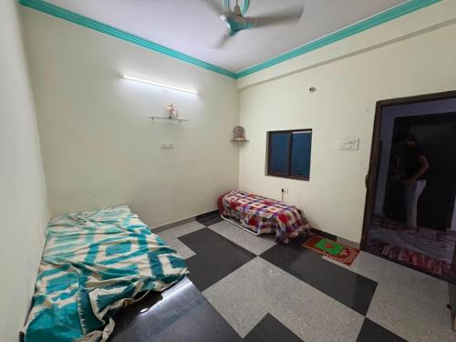 a room with a bed and a flat screen tv at Dixit's Villa in Kānpur