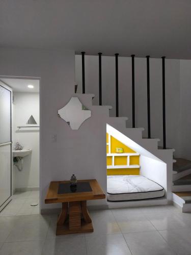 a room with a bed and a wooden table at Loft los Colibries 6 parking option in Tlaxcala de Xicohténcatl