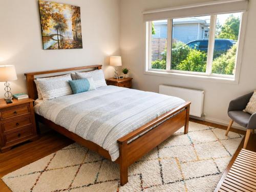 a bedroom with a bed and a window at Bellarine Breeze in Drysdale