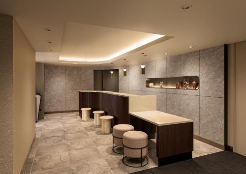 a waiting room with a counter and stools at B:CONTE Asakusa in Tokyo