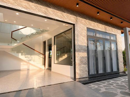 a building with large glass doors on the side of it at Hoàng Vũ VILLA in Nhâm Lăng