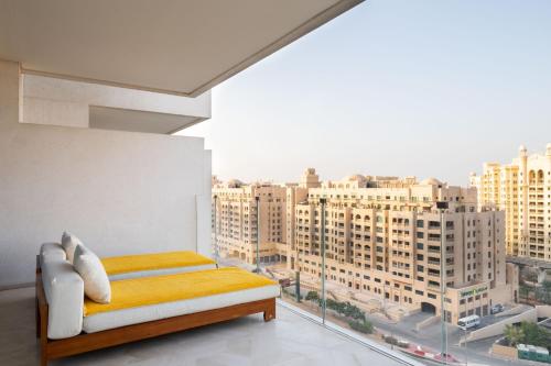 a bedroom with a view of a city from a window at FIVE Palm Residence - Elegant Homes in Dubai