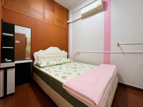 a small bed in a room with a window at Pineapple Express hostel at BKK in Bang Bua Thong Railway Station