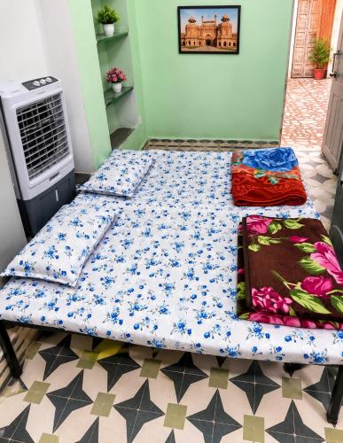 a bed in a room next to a heater at The Heritage Eco Stay in Bikaner