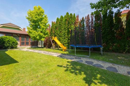 a yard with a playground with a slide at Hotel Velky Meder in Veľký Meder