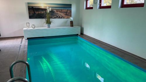 a swimming pool in a room with at Sabines Badehaus mit Innenpool in Steinkoppel