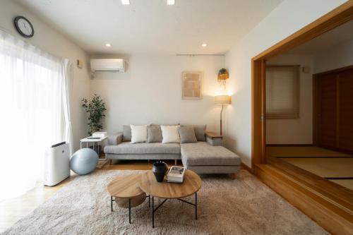 a living room with a couch and a table at Nagano Villa 翠 in Nagano