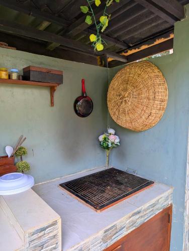 a grill on the side of a wall with a basket at Green Breeze Villa in Katugastota