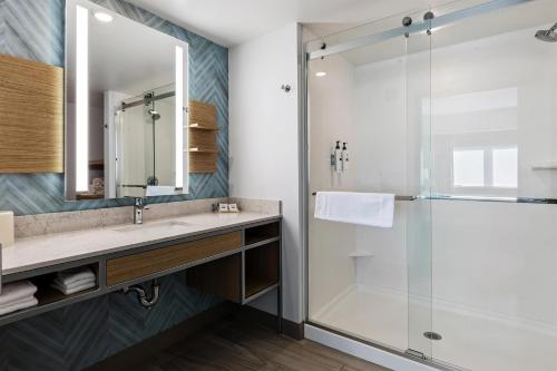 a bathroom with a sink and a shower at Hilton Garden Inn Ithaca in Ithaca