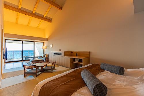 a bedroom with a bed and a living room at さざね in Kyonan