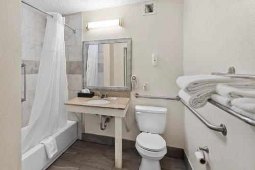 a bathroom with a toilet and a sink and a shower at Quality Inn Sumter near Shaw AFB in Sumter