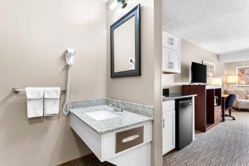 a bathroom with a sink and a mirror at Quality Inn & Suites Gorham White Mountains in Gorham