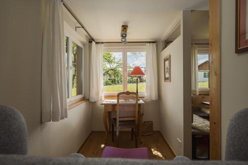 a room with a table and chairs and a window at Das Heinz Altaussee - Your Austrian Home in Altaussee