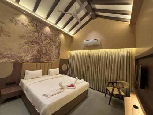 a bedroom with a bed and a tv in it at Hotel Anan Palace in Ābu Road