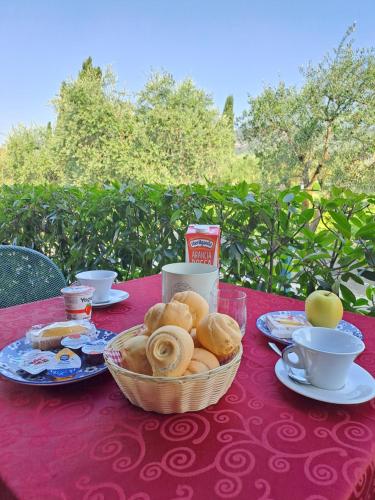 a table with a basket of food on a red table cloth at B&B Locanda Al Pontesel in Garda