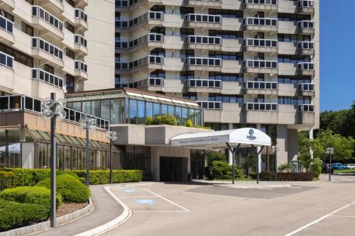 an empty parking lot in front of a building at DoubleTree by Hilton Luxembourg in Luxembourg