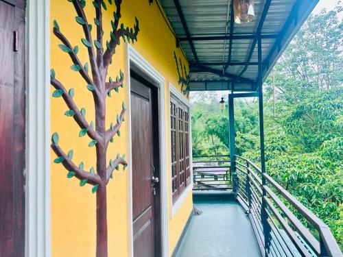 a building with a tree painted on the side of it at K K Kumar Guest in Norwood