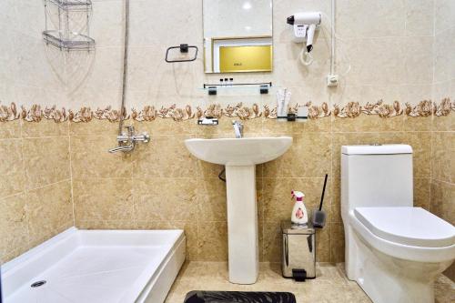 a bathroom with a sink and a toilet and a tub at Dilbar Guest House in Samarkand