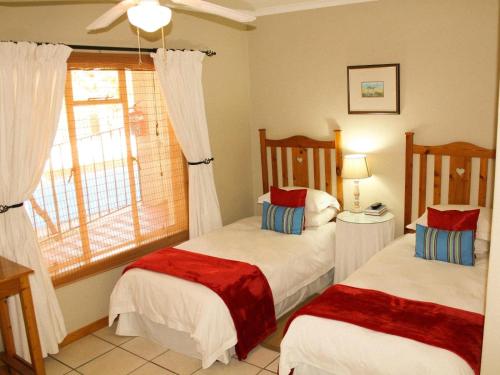 a bedroom with two beds and a window at Blommenberg in Clanwilliam