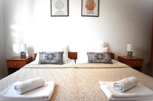 a bedroom with two beds with towels on them at Apartmani Benedetti in Povljana