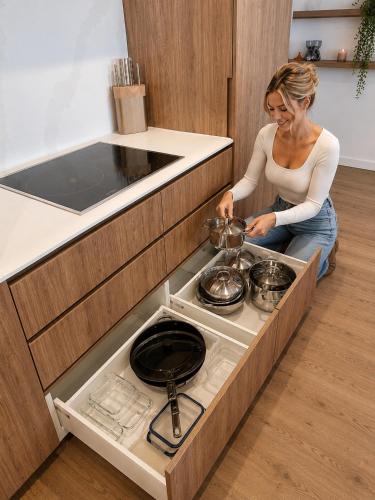 a woman is preparing food in a kitchen at Rise to the top! in Melbourne