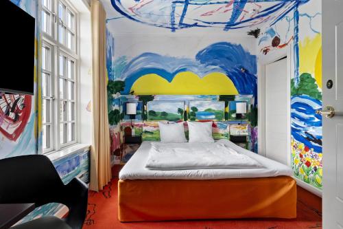 a bedroom with a bed with a painting on the wall at ART Hotel Dalgas, BW Signature Collection in Brande
