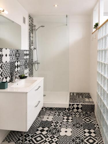a bathroom with a white sink and a shower at L'Oléastre en Luberon in Grambois