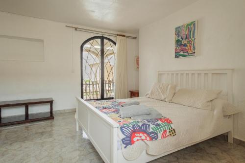 a bedroom with a bed with a colorful blanket on it at El Llano in Sierra de Yeguas