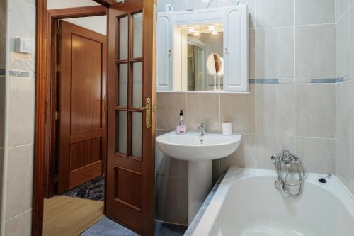 a bathroom with a sink and a toilet and a mirror at El Llano in Sierra de Yeguas