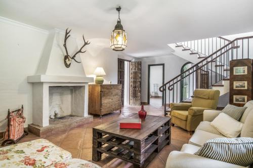 a living room with a couch and a fireplace at Cortijo Cantarranas - Tarifa in Tarifa