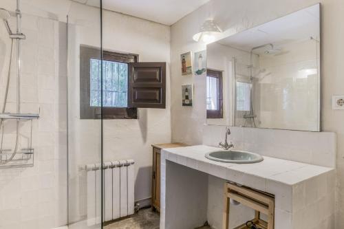 a white bathroom with a sink and a shower at Cortijo Cantarranas - Tarifa in Tarifa