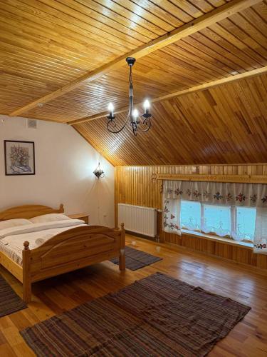 a bedroom with a bed and a wooden ceiling at Плай in Khmelnytskyi