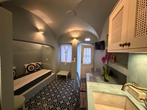 a bathroom with a sink and a toilet in a room at Dimael Mansion in Fira